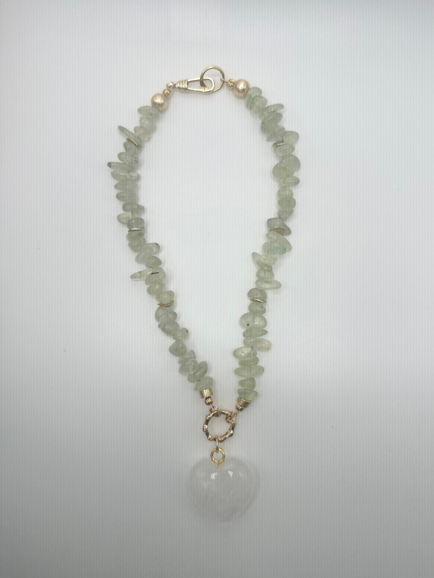 The Quarry: green stones with white heart pendant