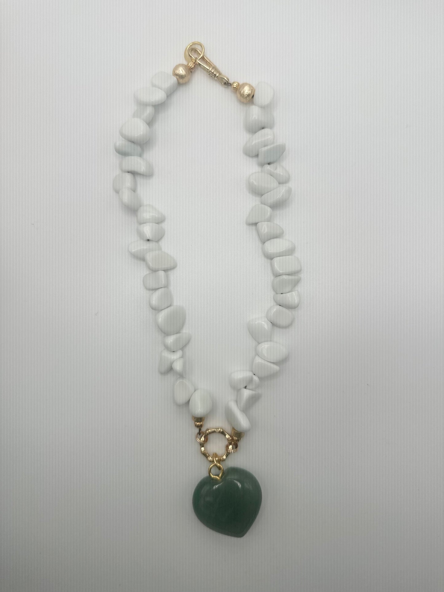 The Quarry: white stones with green heart pendant