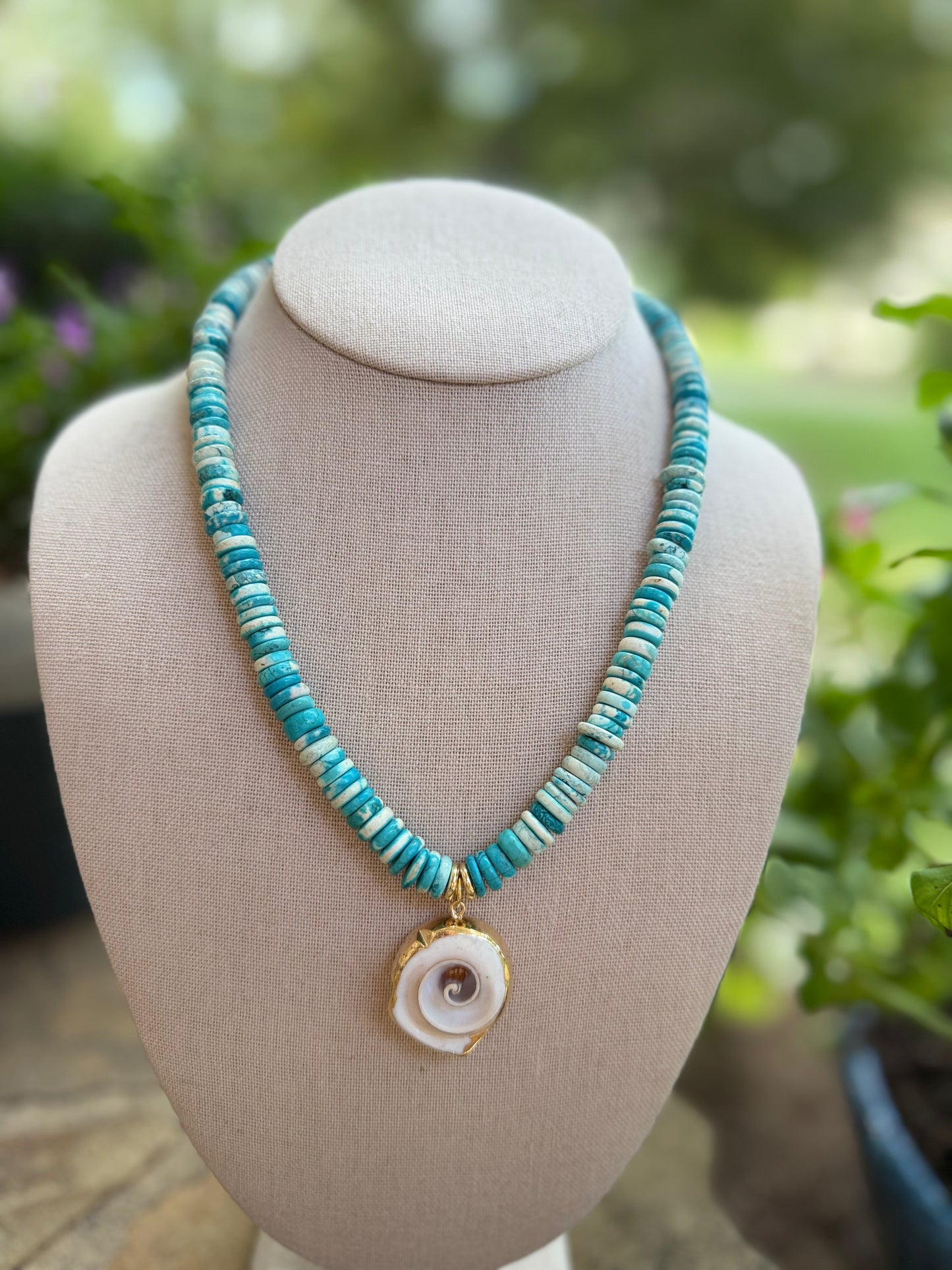 Beachy: turquoise or green with a shell pendant