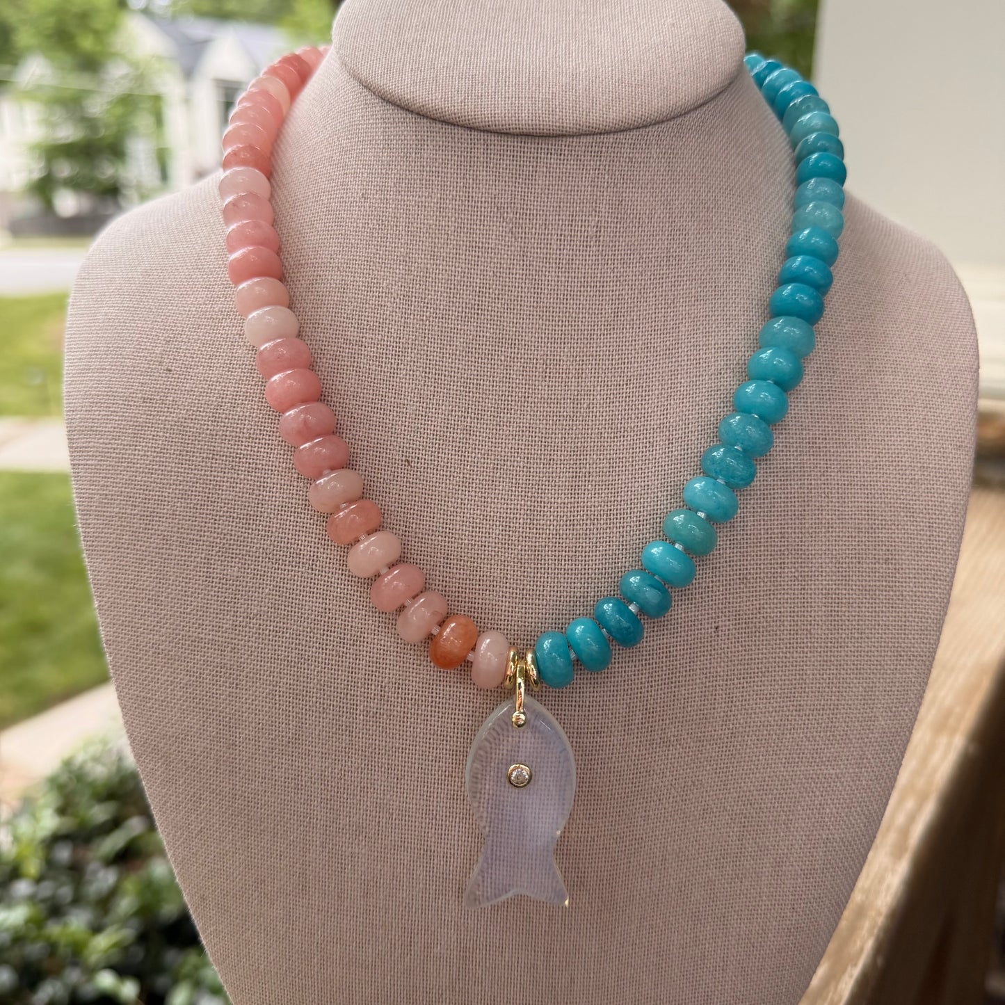 Flock: half aqua half pink with a fish pendant