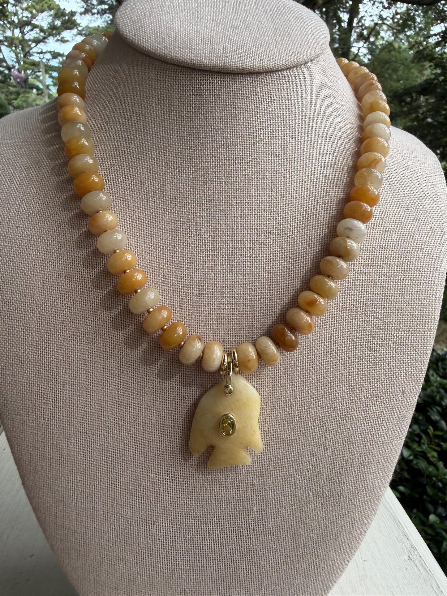 Flock: cream and light yellow with a fish pendant