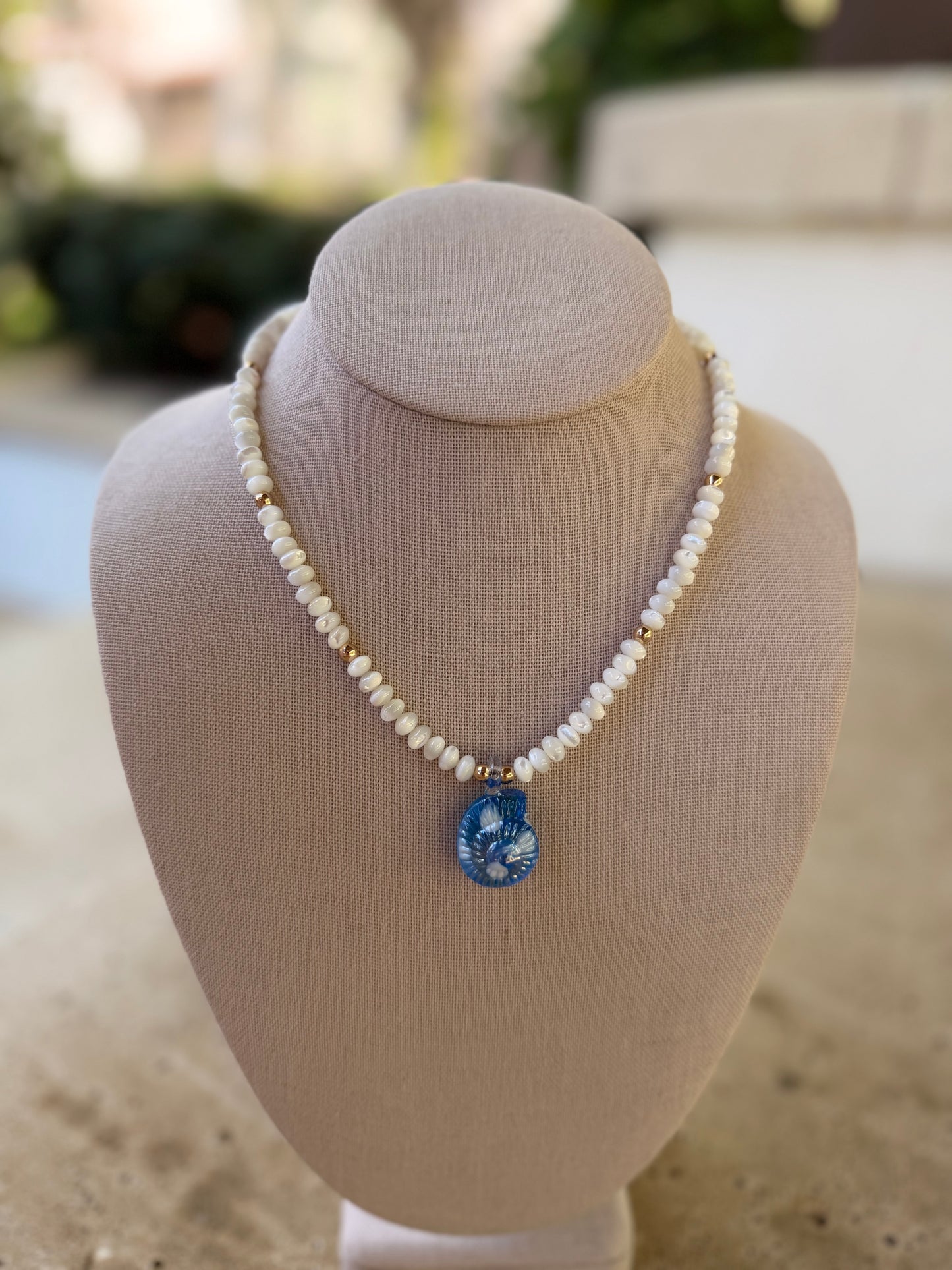 Flock: white mother of pearl with blue nautilus pendant