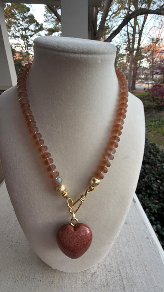 Flock: translucent caramel brown with a sparkly bronze heart pendant