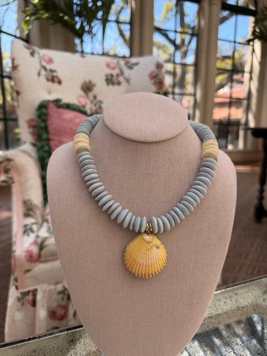 Beachy: light blue recycled glass beads with a yellow shell pendant