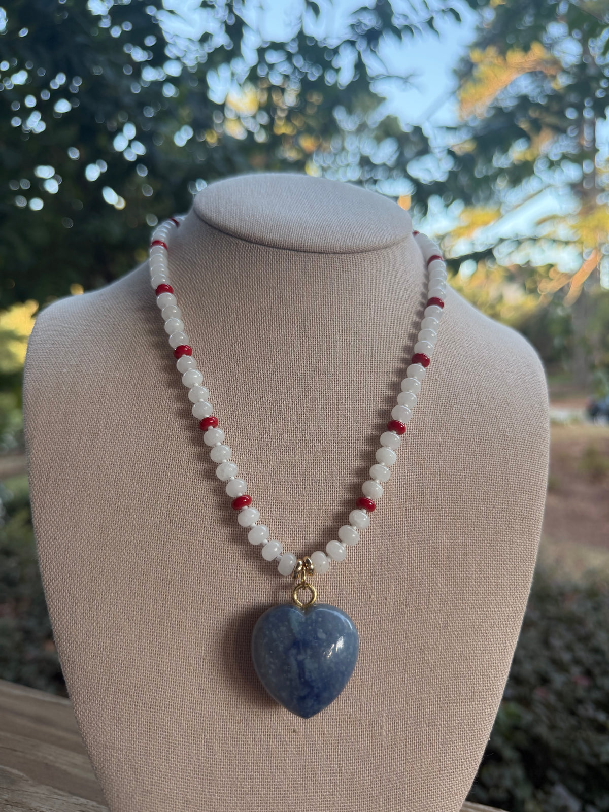 Game Day🏈:  white and red with blue heart pendant