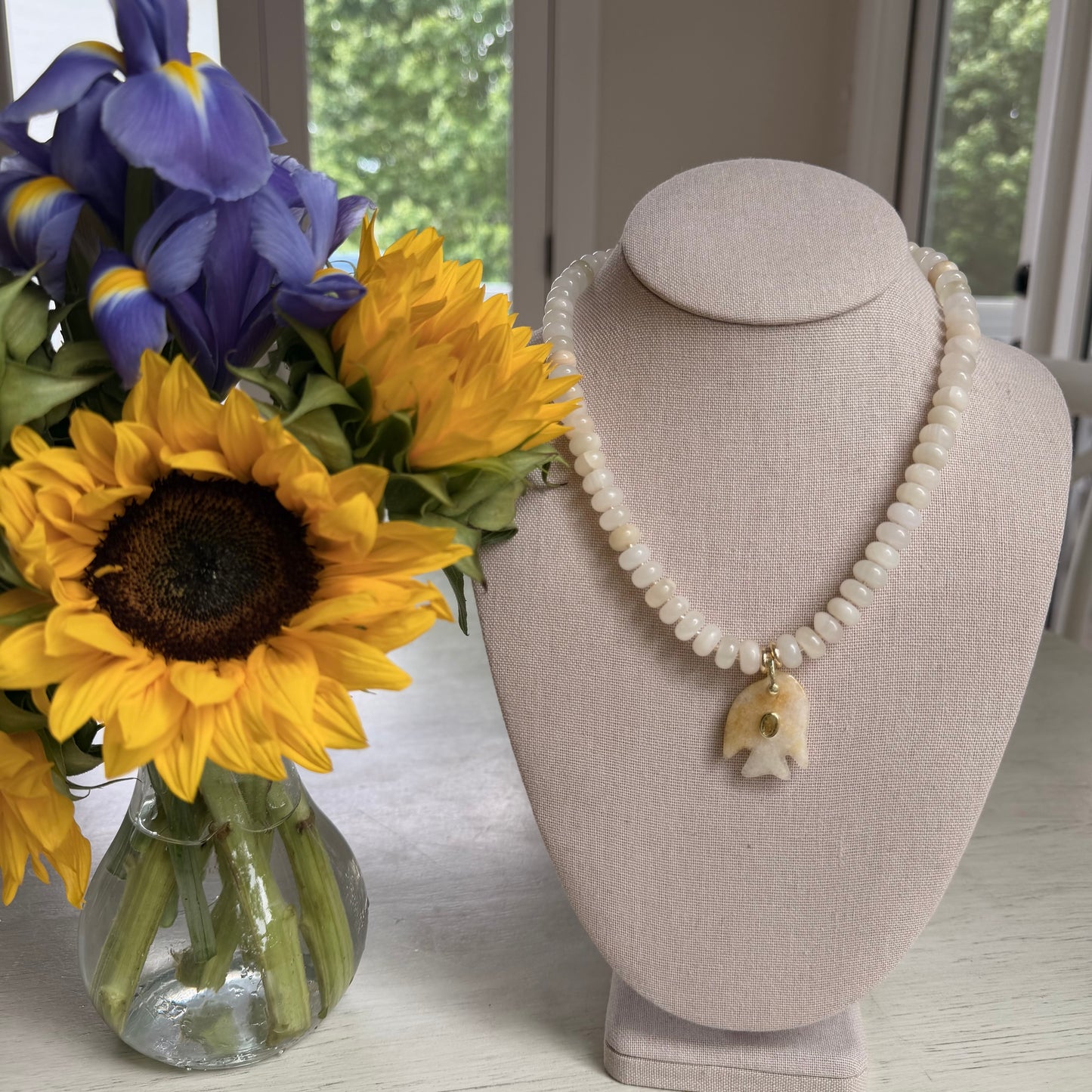 Flock: cream and light yellow with a fish pendant