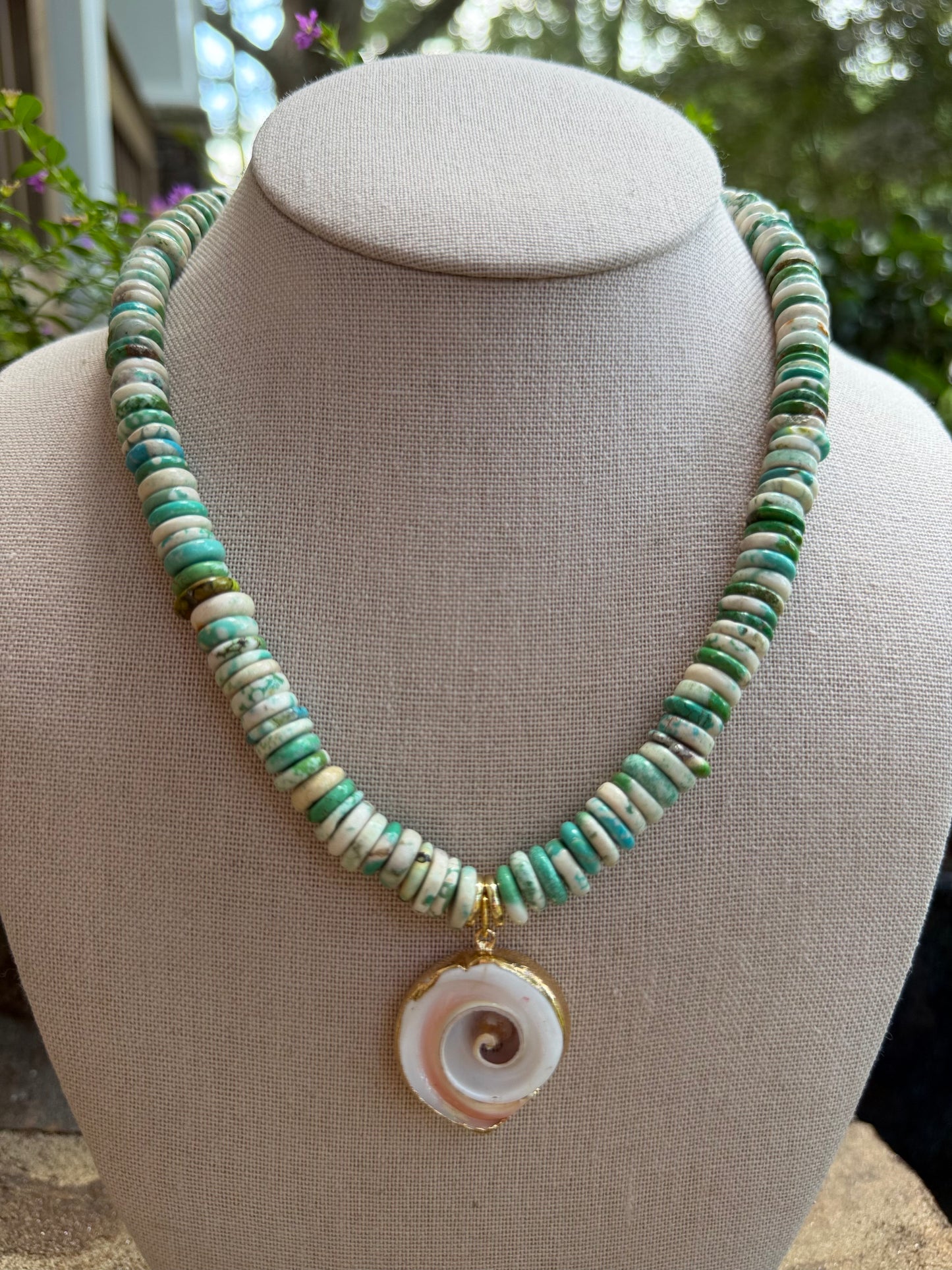 Beachy: turquoise or green with a shell pendant