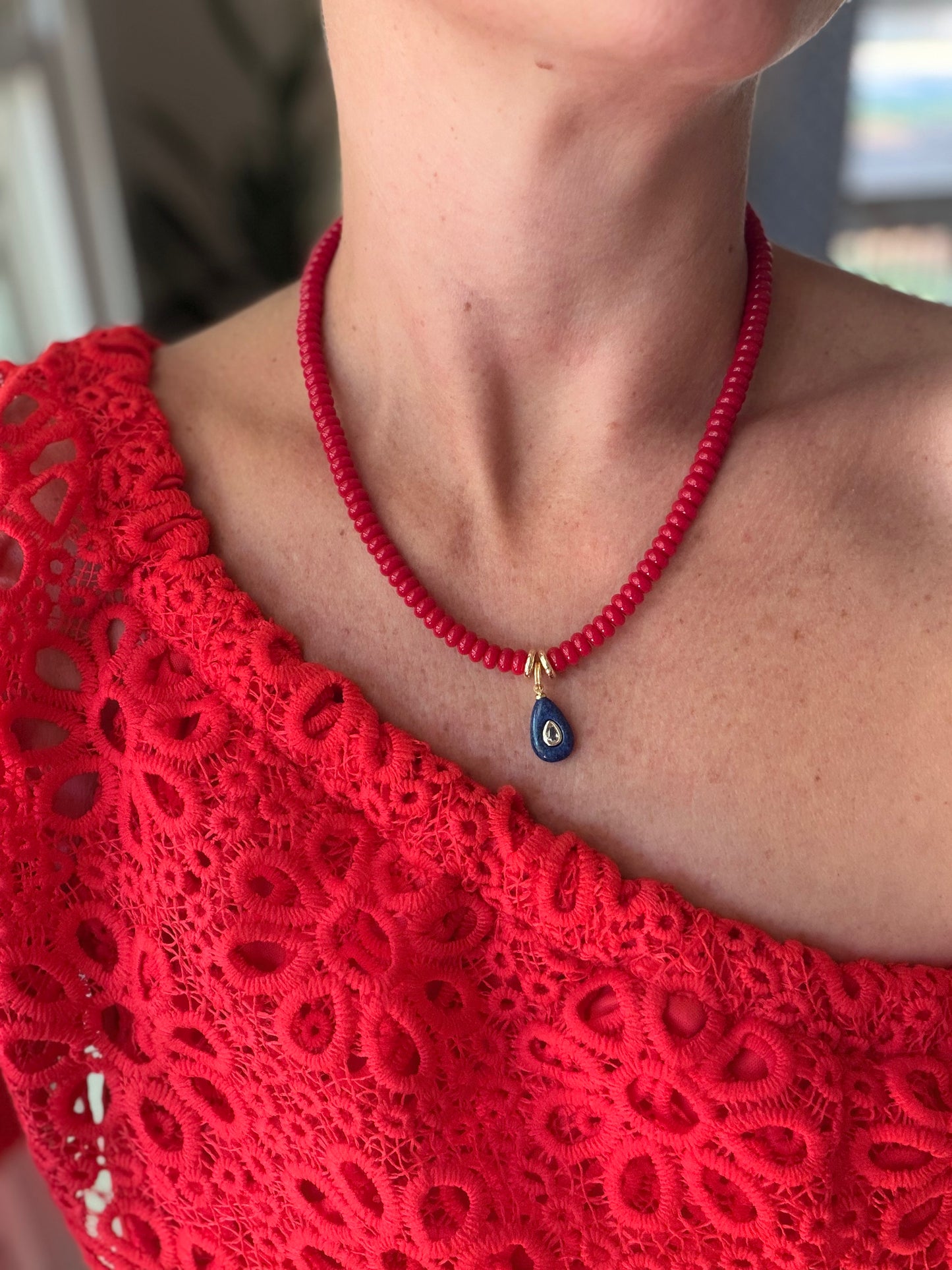 American: 6mm beaded red with small blue pendant