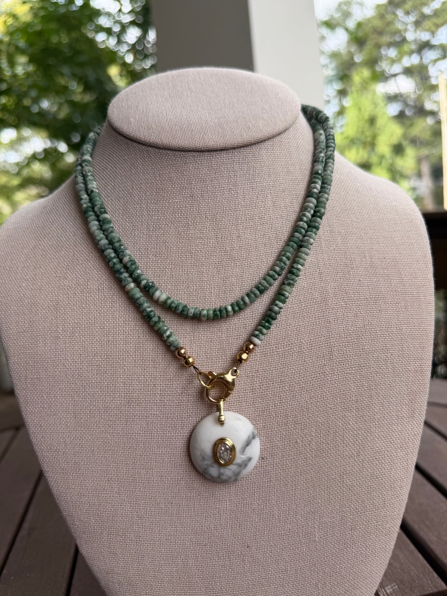 Double wrap: green and white beads with a round, white pendant