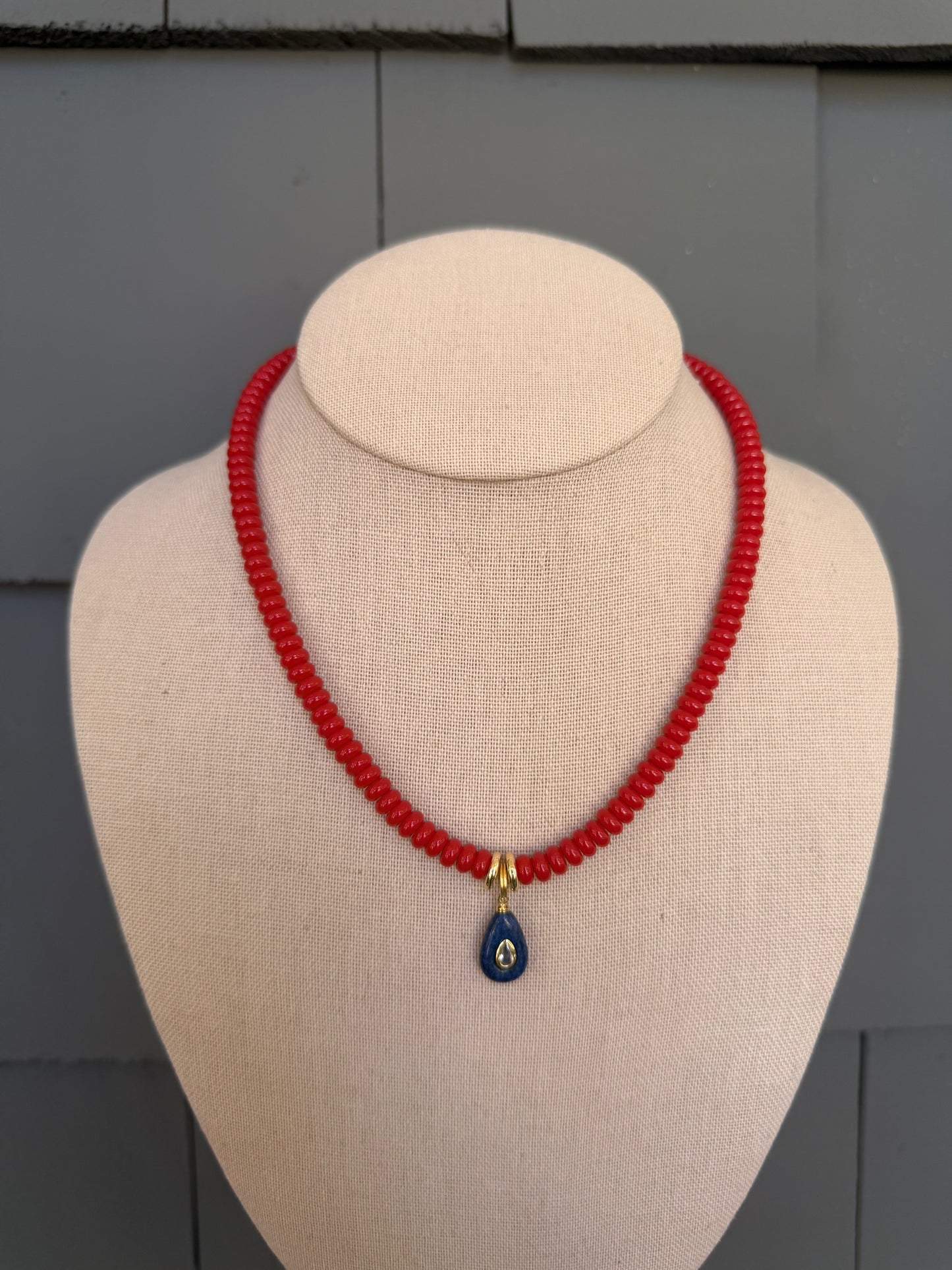 American: 6mm beaded red with small blue pendant