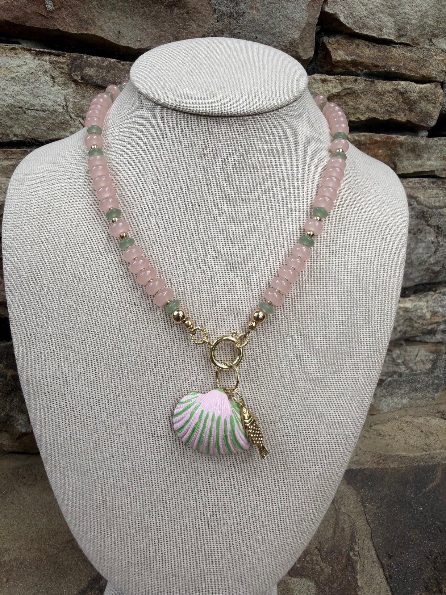Beachy: pink and green, with a matching hand painted shell and fish charm