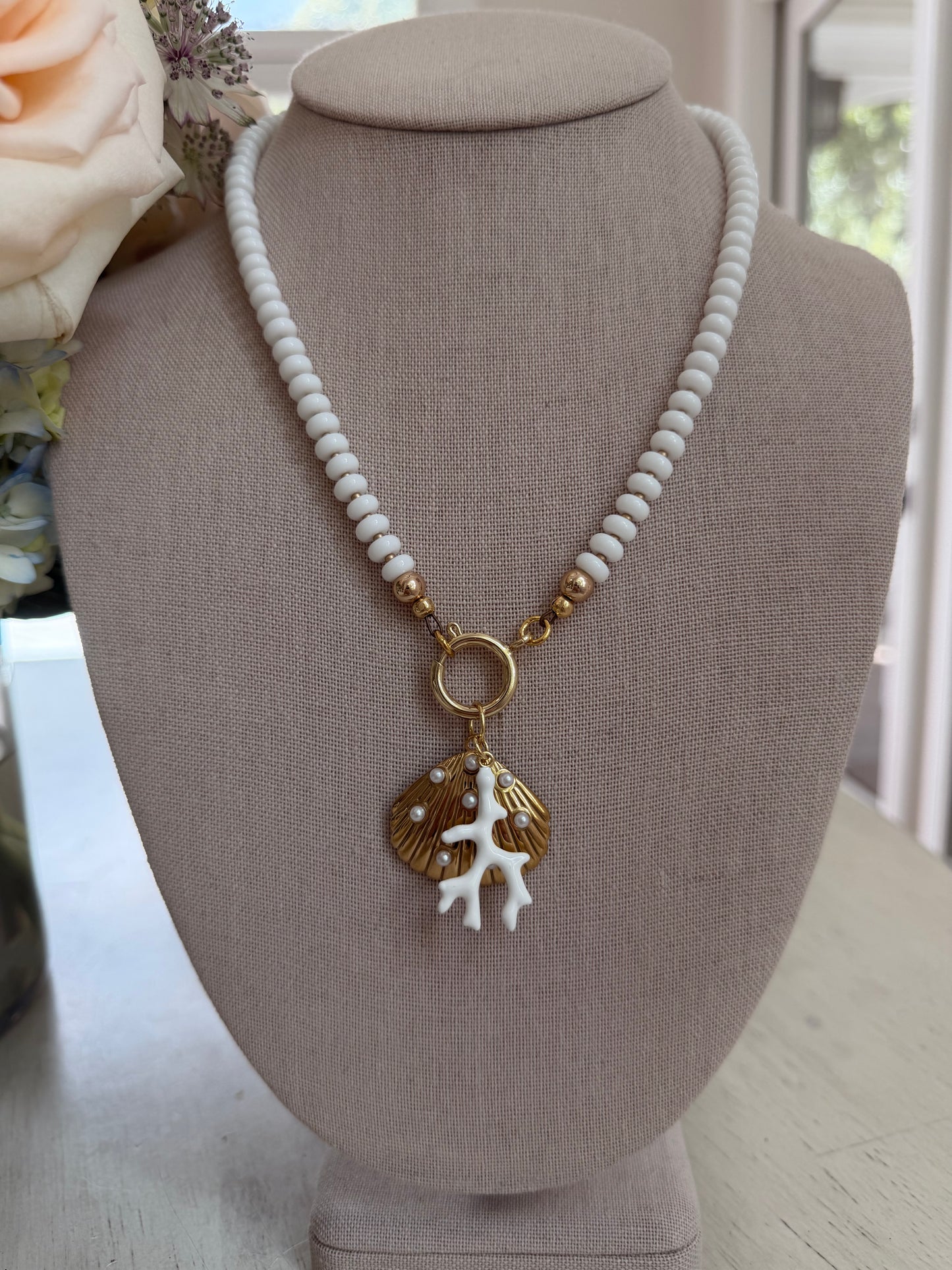 Beachy: white beads with a coral and shell charm